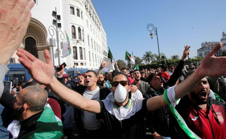 A demonstrator wearing a face mask gestures during an anti-government protest in Algiers, February 28
