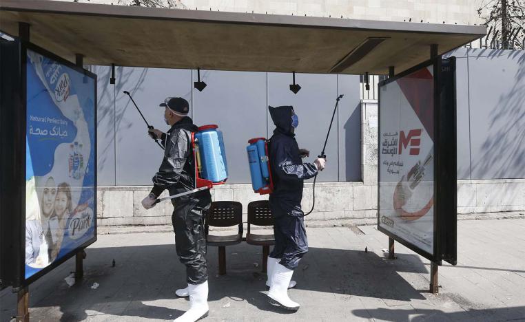 Syrian municipal workers spray disinfectant against the COVID-19 coronavirus in Damascus 
