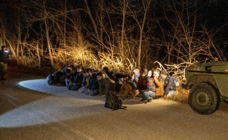 Greek Army soldiers detain a group of migrants that crossed from Turkey to Greece, near the village of Protoklisi, in the region of Evros, Greece