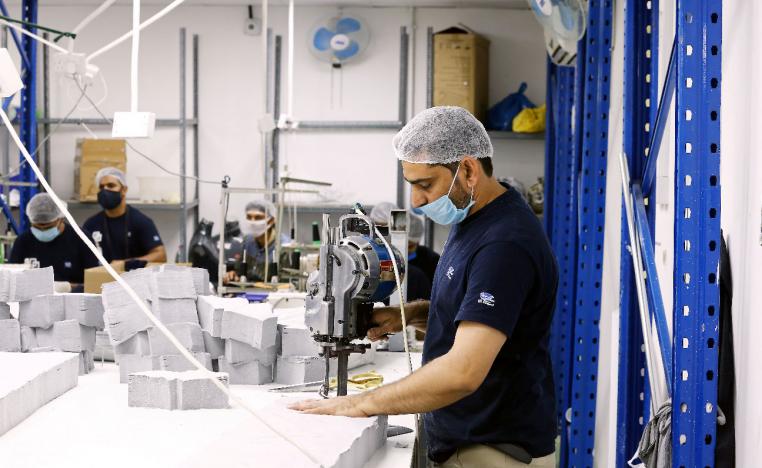 A worker sews pieces of cloth to make face masks at a factory, following the outbreak of coronavirus disease (COVID-19), in Ajman, United Arab Emirates