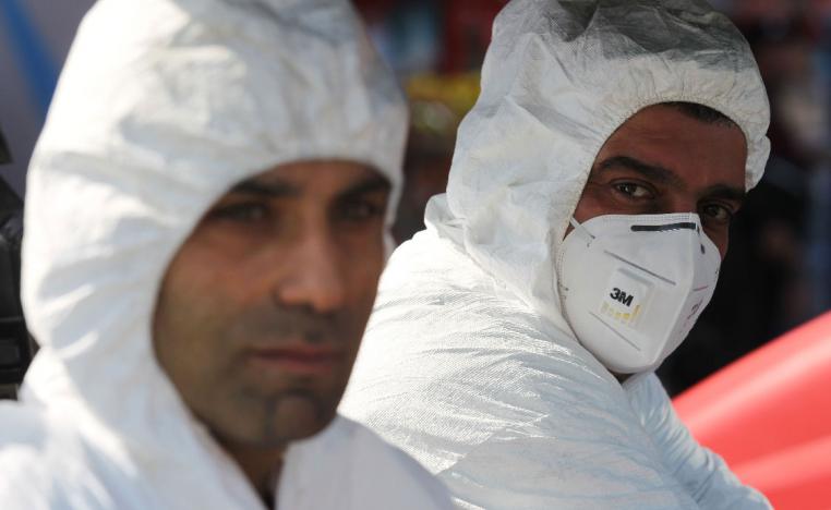 An Iraqi Civil Defence teams disinfects the streets of Sadr City in Baghdad