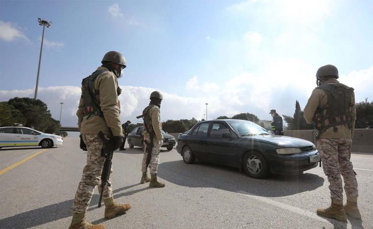 Jordanian army members and police personnel guard at a checkpoint during the second day of a nationwide curfew