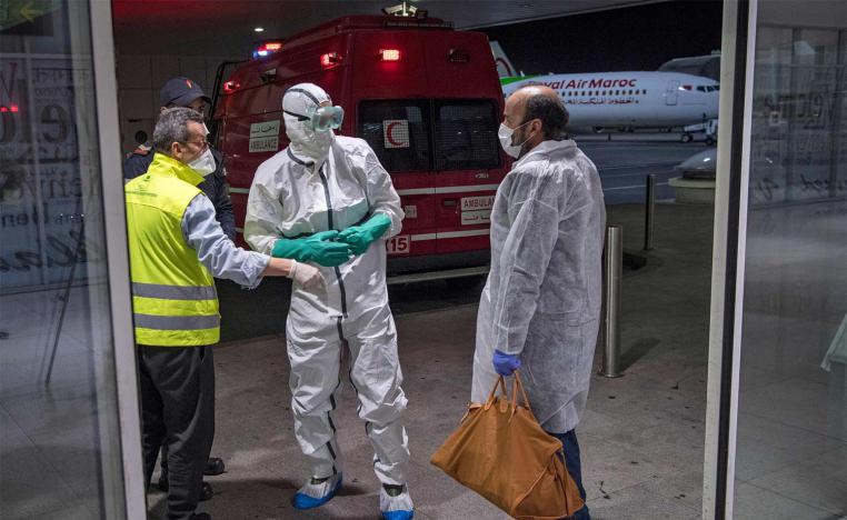 Moroccan health workers scan passengers arriving from Italy for coronavirus COVID-19 at Casablanca Mohammed V International Airport 