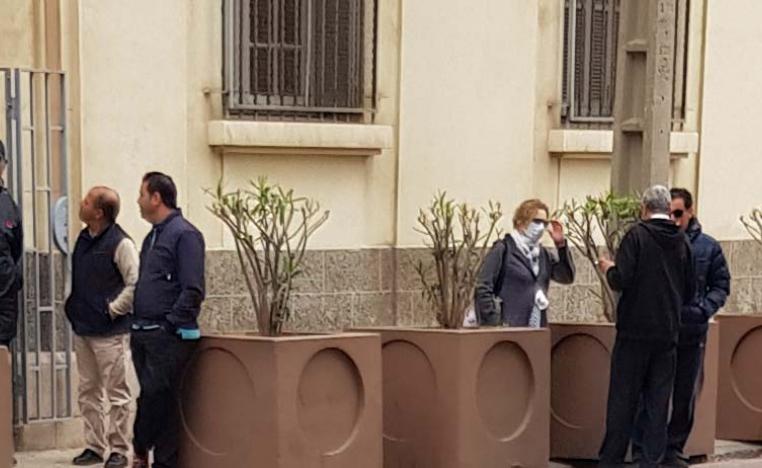 A woman wearing a protective mask outside the Italian school in Casablanca