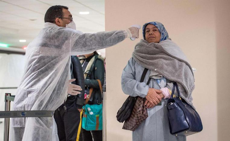 Moroccan health workers scan passengers arriving from Italy for coronavirus COVID-19 at Casablanca Mohammed V International Airport on March 3