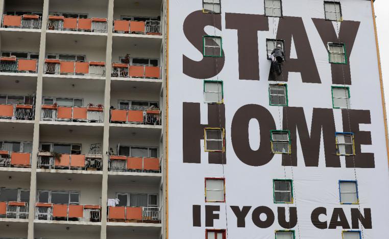 A billboard is installed on an apartment building in Cape Town, South Africa