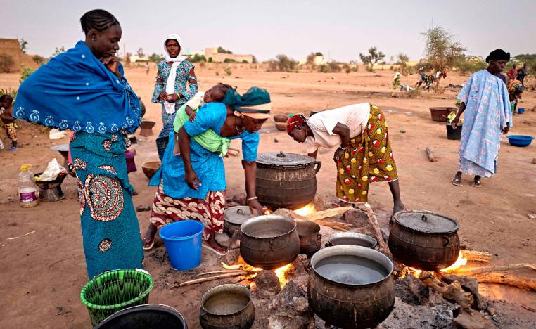 Displaced women prepare the dinner in a courtyard in Sevare in central Mali on February 26