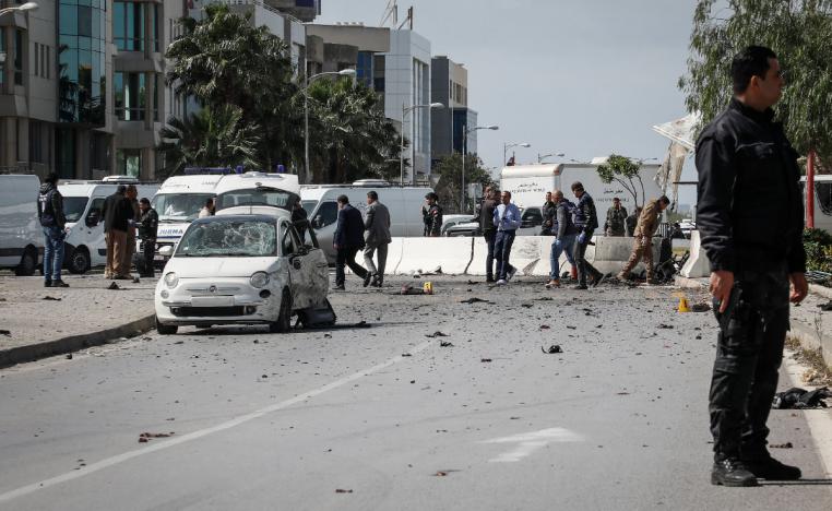 An armed Tunisian police officer at the site of an explosion near the US embassy