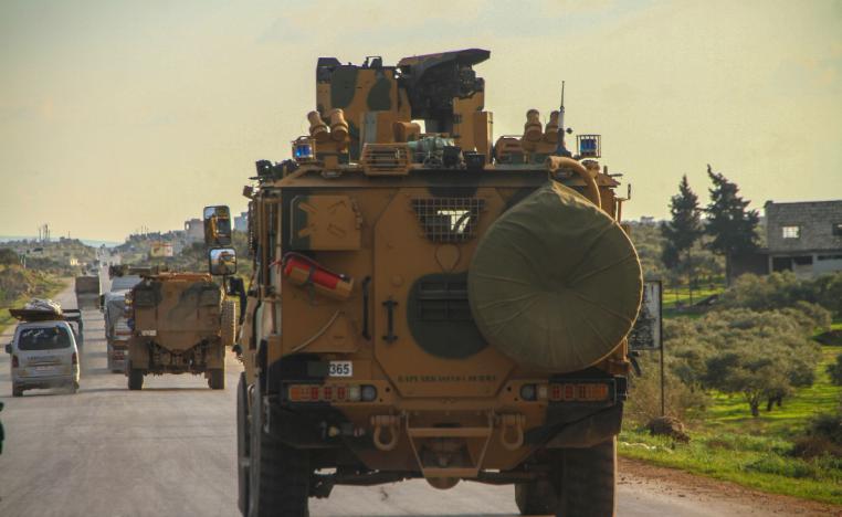 A Turkish military convoy drives along the M4 highway in northern Syria