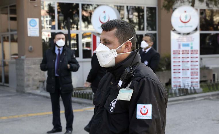 Security officials stand at the entrance of Zekai Tahir Burak Hospital where 17 passengers of a Turkish Airlines flight from Tehran