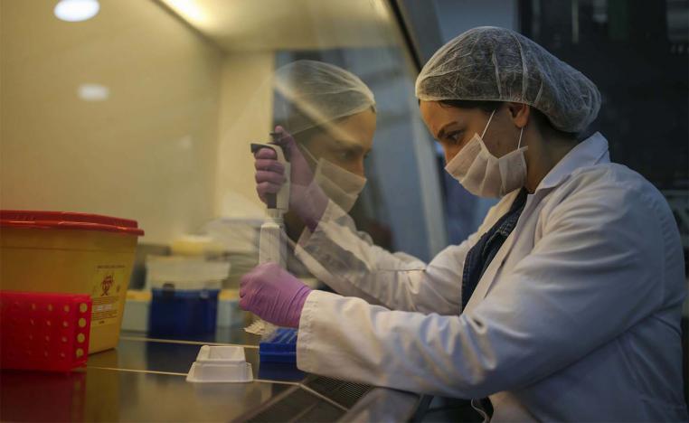 Research and development company employee works on the production of coronavirus testing kits in Gebze