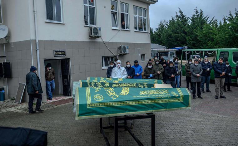 Coffins of people who officially died of contagious diseases are displayed in front of relatives and officials