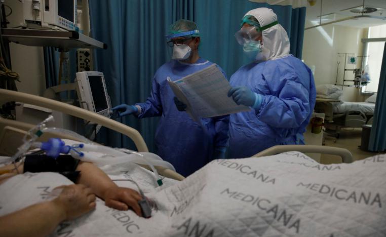 A nurse and a doctor take care of a patient suffering from the coronavirus disease (COVID-19) at an intensive care unit of the Medicana International Hospital in Istanbul, Turkey