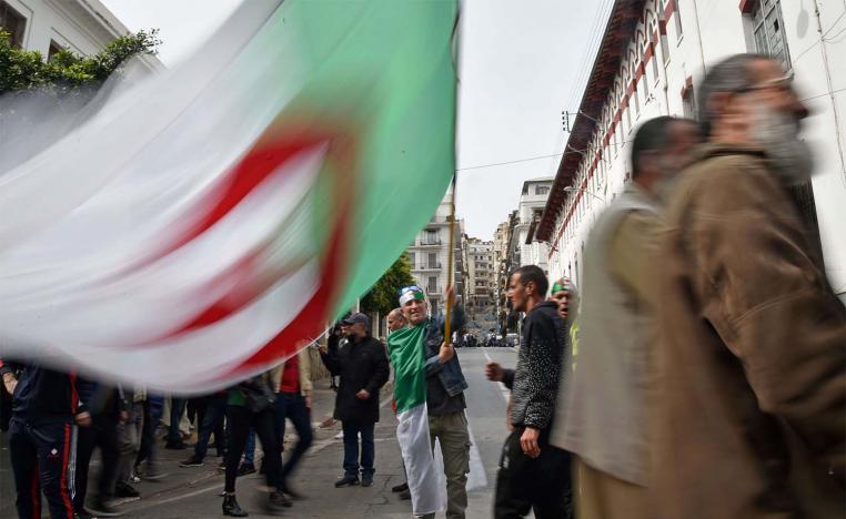 An Algerian protester waves the national flag during a weekly anti-government demonstration in Algiers on March 13