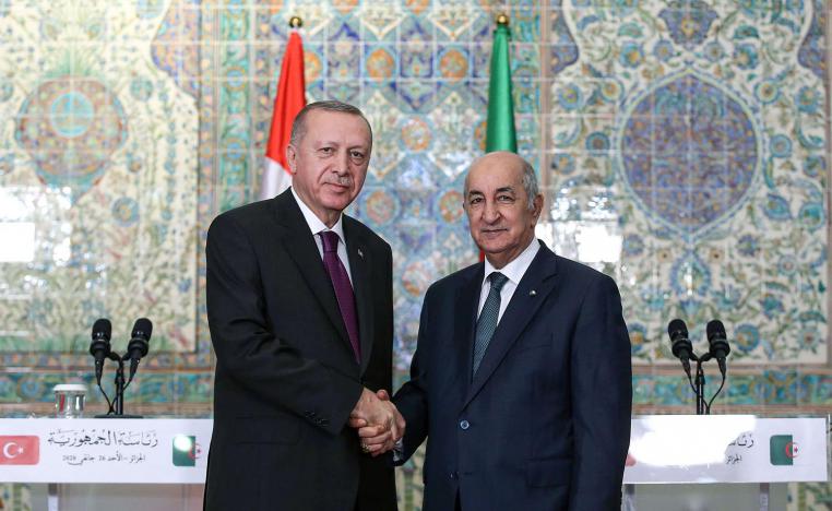 Erdogan (L) shaking hands with Tebboune