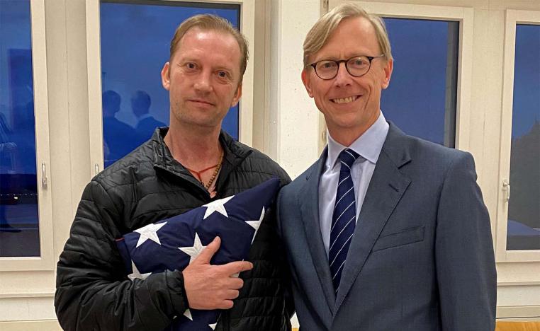 Michael White, a freed US Navy veteran detained in Iran since 2018, poses with US Special Envoy Brian Hook