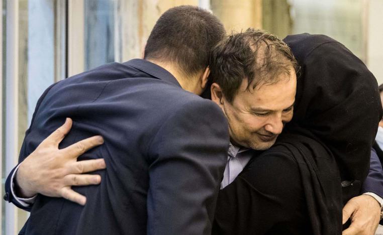 Majid Taheri hugs his children upon his arrival at Tehran's Imam Khomeini International Airport