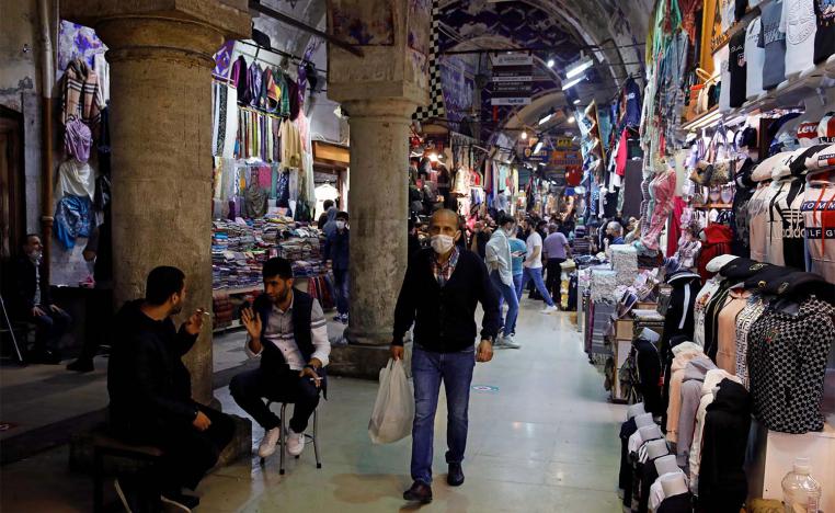 A man wearing a protective face mask walks at Grand Bazaar