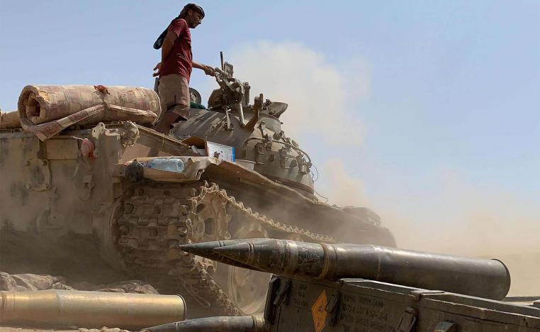 A fighter loyal to Yemen's separatist Southern Transitional Council (STC) stands atop a tank