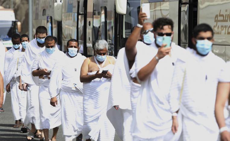 Muslim pilgrims enter Namira Mosque in Arafat, as they wear masks and keep social distance to protect themselves against coronavirus
