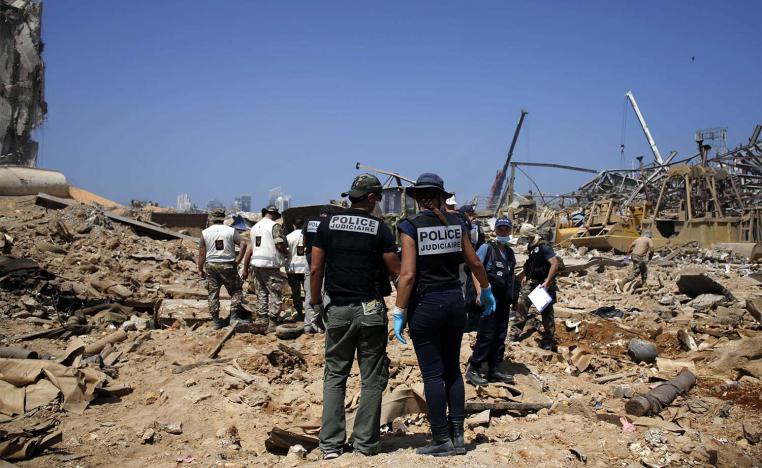 French criminal police officers work on the site of the massive explosion in the port of Beirut