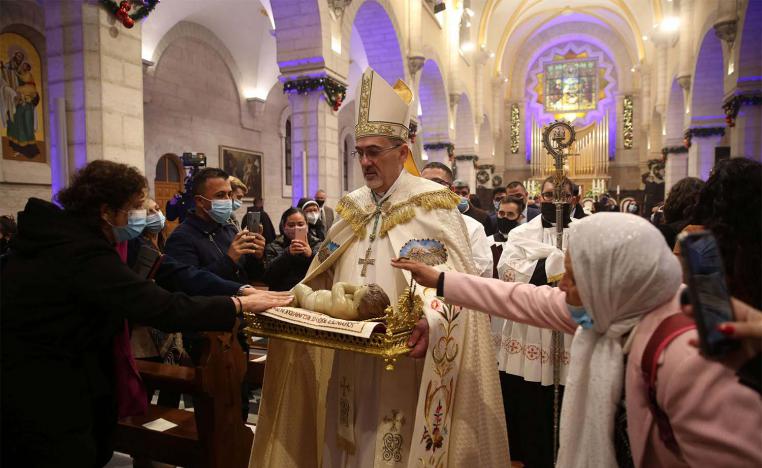 Apostolic Administrator of the Latin Church in the Holy land Pierbattista Pizzaballa (C), leads a Christmas midnight mass at the Church of the Nativity in Bethlehem