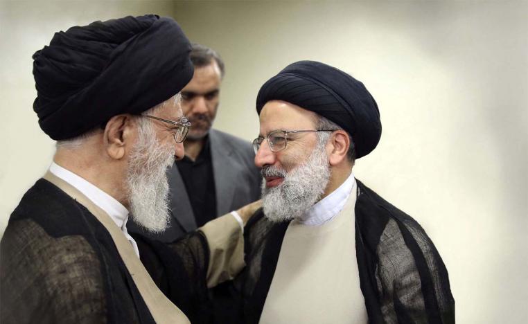 ranian Supreme Leader Ayatollah Khamenei talks to Ebrahim Raisi