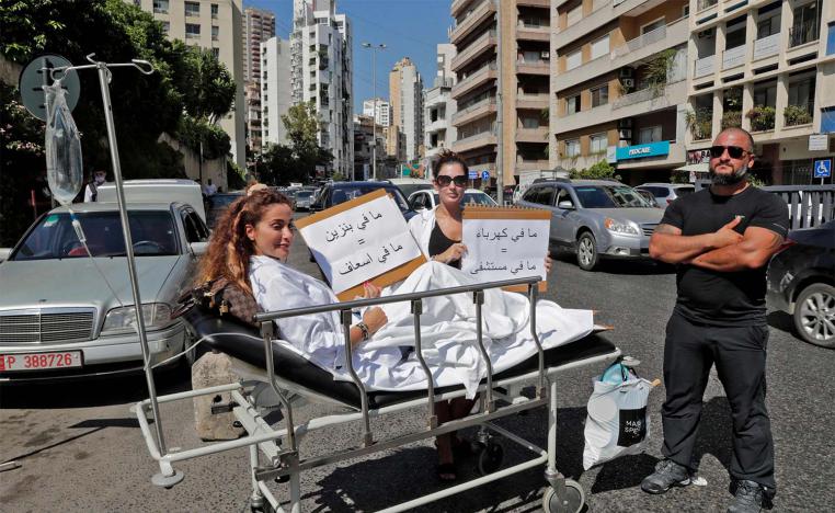 "no gasoline = no ambulance," reads the sign