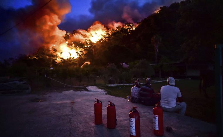 The fires forced thousands of residents and tourists to flee homes or vacation resorts 