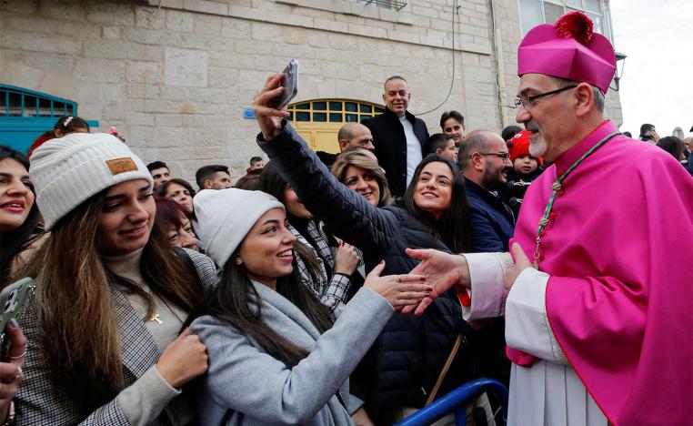 Pizzaballa greets people as he arrives to attend Christmas celebrations in Bethlehem
