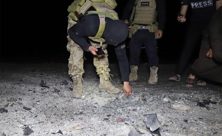 Fighters affiliated with the Hayat Tahrir al-Sham jihadist group in Syria inspect the site of a reported drone attack 