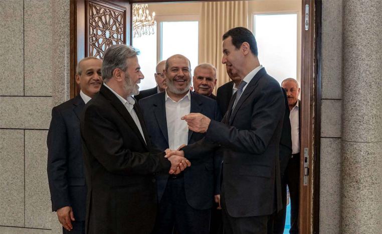 Syia's President Bashar al-Assad (R) receiving Hamas chief of Arab relations, Khalil al-Hayya
