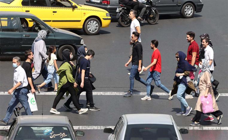 Iranians crossing a road in Tehran