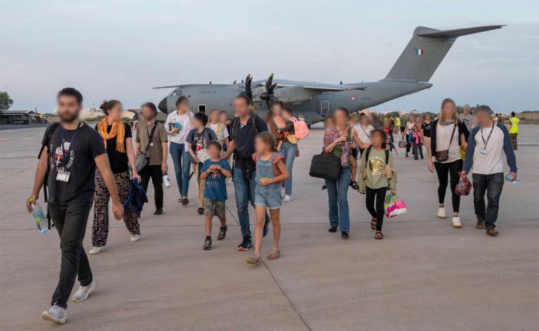 French citizens arrive at the air base of the French Army forces stationed in Djibouti after being evacuated from Sudan 