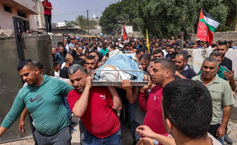 Mourners carry the body of Palestinian teenager Mohamed Fayez Balhan