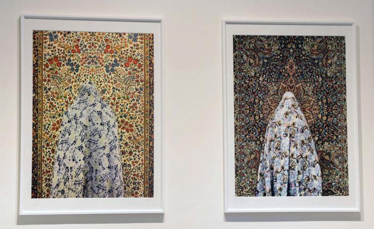 The women are photographed from behind and the pattern of their chador