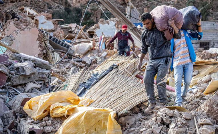 People conduct salvage operations in the aftermath of the deadly  earthquake