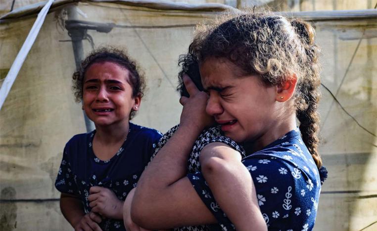 Children cry during the funeral of the Faojo family, killed in Israeli bombing on Rafah 
