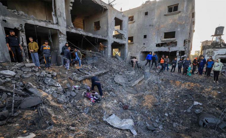 Rescuers look for survivors in the rubble of the al-Agha family home following an Israeli strike in Khan Younis on the southern Gaza Strip