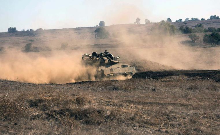 An Israeli tank moves to a position during a drill in the annexed Golan Heights