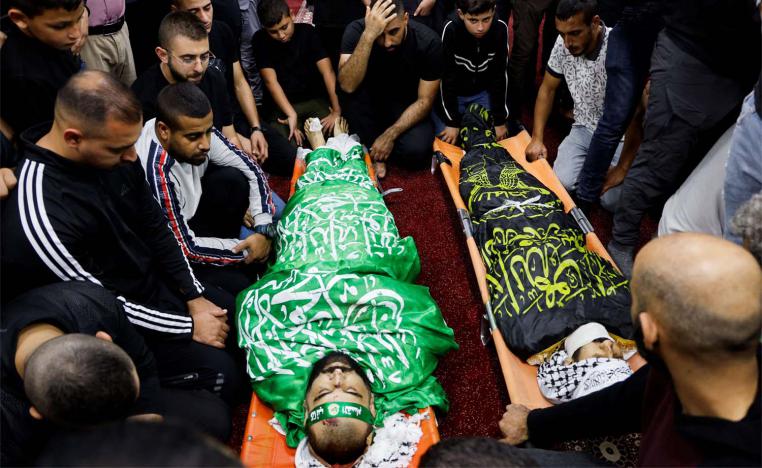 People attend a funeral for 3 Palestinians who were killed when Israeli forces raided Jenin refugee camp