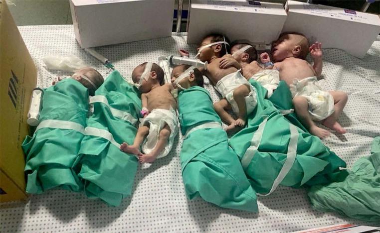 Newborns are placed in bed after being taken off incubators in Gazas Al Shifa hospital after power outage