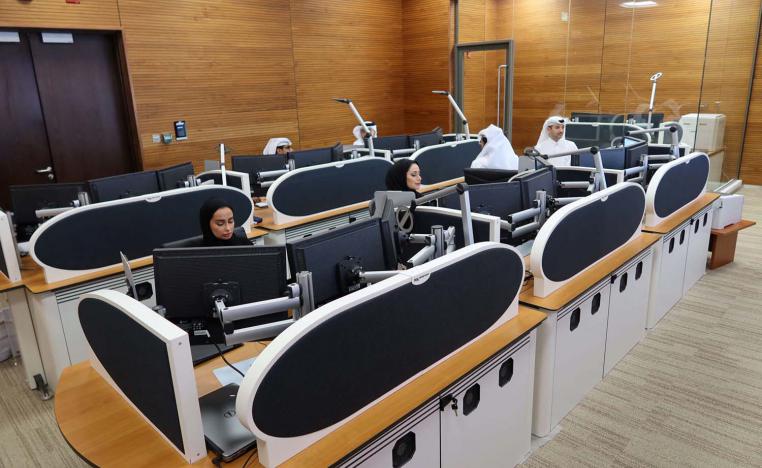 Qatari diplomats work inside an operation room set up to coordinate the truce and release of hostages between Israel and Hamas