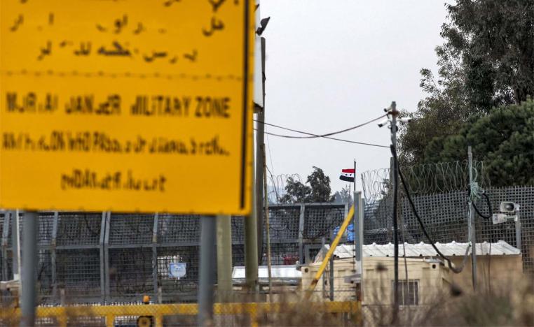 A Syrian flag flies at the Quneitra checkpoint across the fence separating the Israeli-annexed Golan Heights from Syria