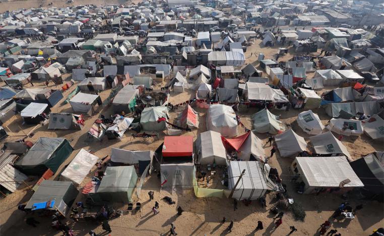 Displaced Palestinians, who fled their homes due to Israeli strikes, shelter in a tent camp in Rafah