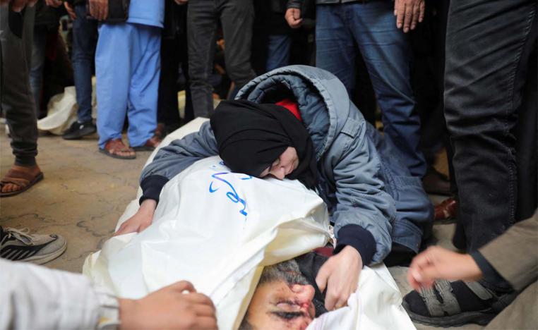 A mourner embraces the body of a Palestinian killed in an Israeli strike on Khan Younis