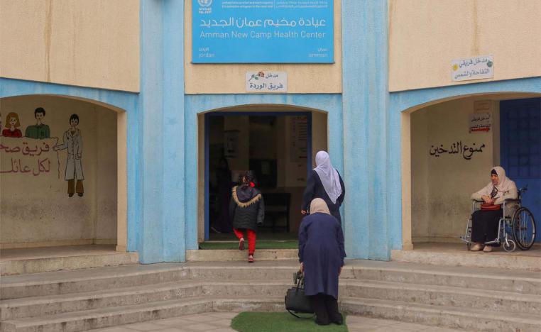 Women enter a health care center run by UNRWA at Amman new camp for Palestinian refugees