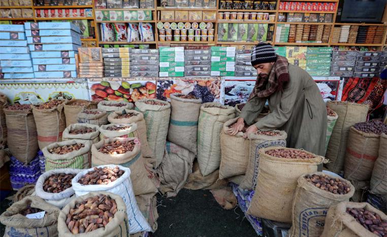 An Egyptian seller waits for customers at his dates shop ahead of the Muslim fasting month of Ramadan