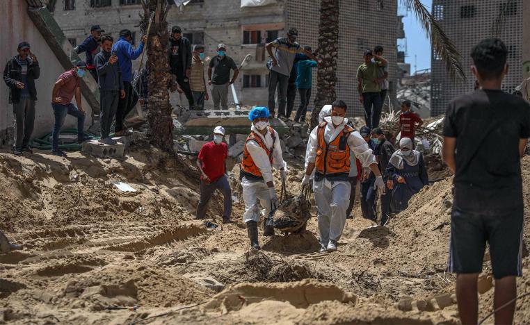 People and health workers unearth bodies found at Nasser Hospital in Khan Yunis in the southern Gaza Strip