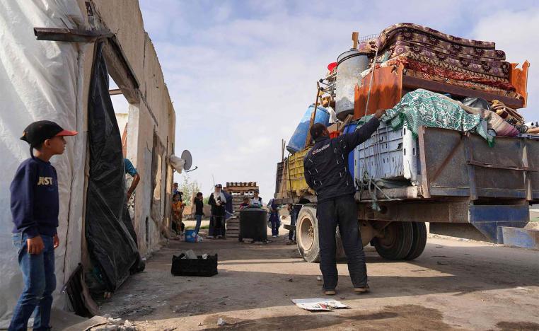 Displaced Palestinian families load their belongings on trucks to leave Rafah towards Khan Yunis